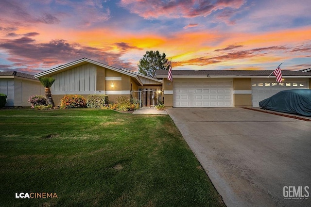 single story home with a yard and a garage