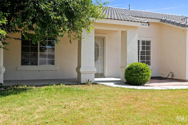 3410 Kimmie Rachelle Ct, Bakersfield, CA 93313 - entrance to property featuring stucco siding, a lawn, and a tiled roof