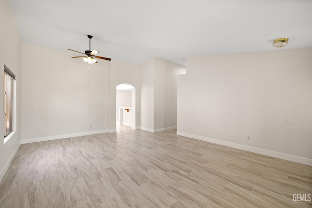 3410 Kimmie Rachelle Ct, Bakersfield, CA 93313 - spare room with arched walkways, vaulted ceiling, a ceiling fan, and light wood-type flooring