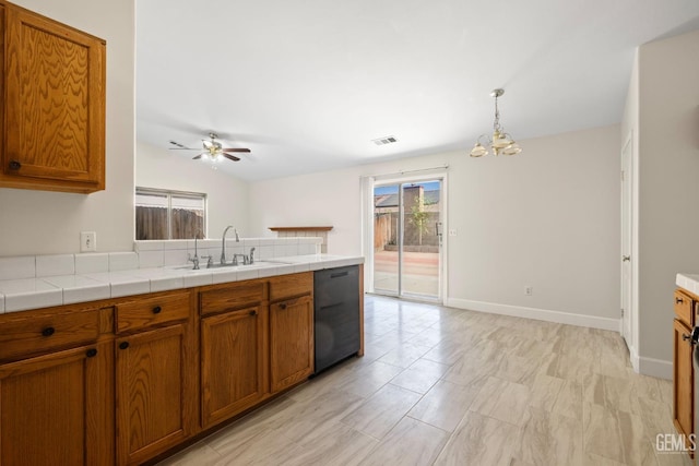 3410 Kimmie Rachelle Ct, Bakersfield, CA 93313 - kitchen with dishwasher, brown cabinets, plenty of natural light, and lofted ceiling