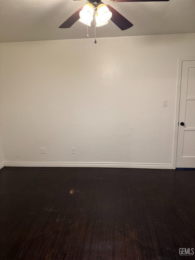 unfurnished room with ceiling fan and dark wood-type flooring