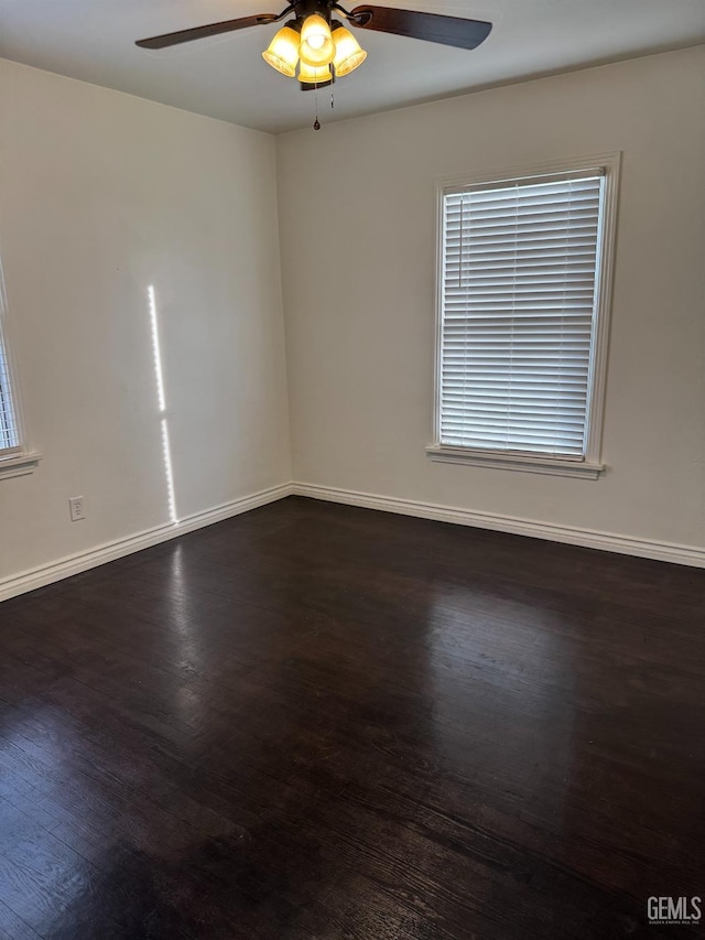 unfurnished room with dark hardwood / wood-style flooring and ceiling fan