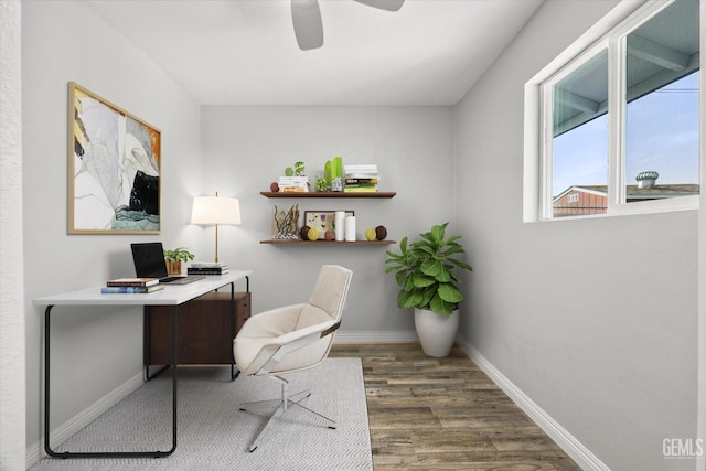 office featuring baseboards, wood finished floors, and ceiling fan