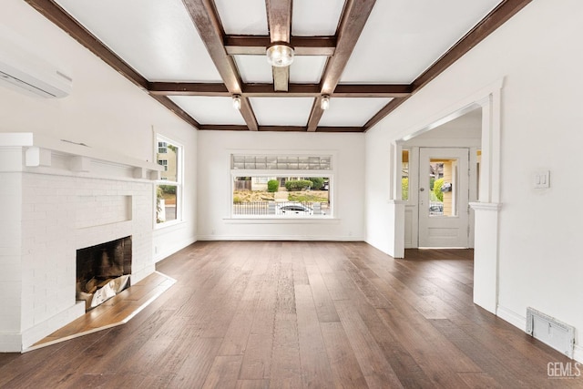 1940 S La Salle Ave, Los Angeles, CA 90018 - unfurnished living room featuring hardwood / wood-style flooring, coffered ceiling, beamed ceiling, a brick fireplace, and a wall mounted air conditioner