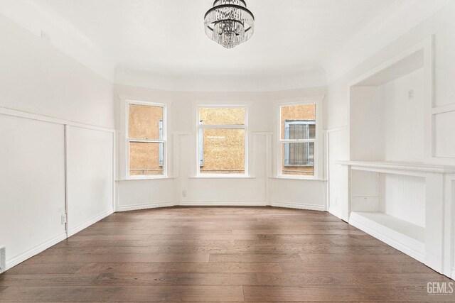 1940 S La Salle Ave, Los Angeles, CA 90018 - unfurnished dining area with a chandelier, hardwood / wood-style floors, and a decorative wall