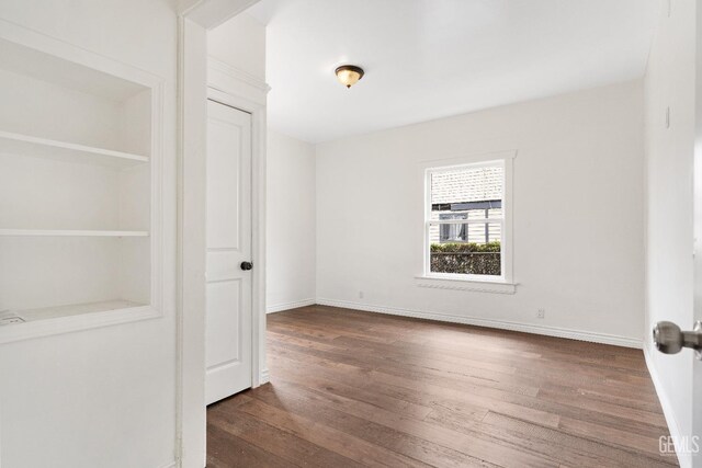 1940 S La Salle Ave, Los Angeles, CA 90018 - unfurnished bedroom featuring wood finished floors and baseboards