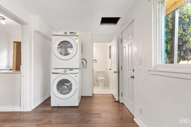 1940 S La Salle Ave, Los Angeles, CA 90018 - clothes washing area with stacked washer / dryer, dark wood-style flooring, and baseboards