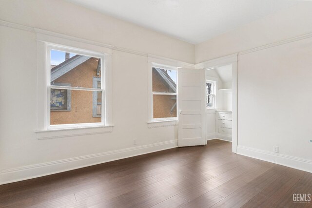 1940 S La Salle Ave, Los Angeles, CA 90018 - empty room with dark wood-style flooring, plenty of natural light, and baseboards