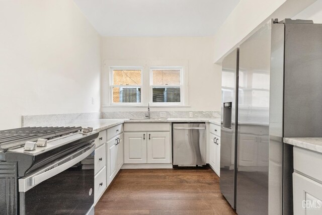1940 S La Salle Ave, Los Angeles, CA 90018 - kitchen featuring stainless steel appliances, a sink, white cabinetry, and dark wood-style floors