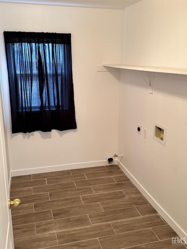 washroom with dark wood-style flooring, baseboards, hookup for a washing machine, and laundry area