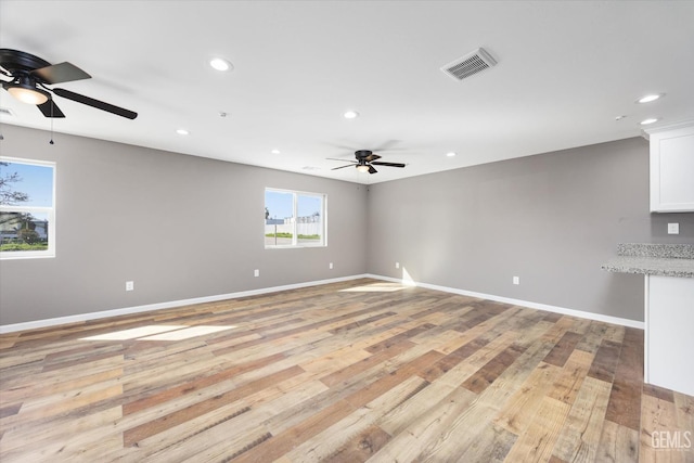 unfurnished room featuring baseboards, recessed lighting, visible vents, and light wood-style floors