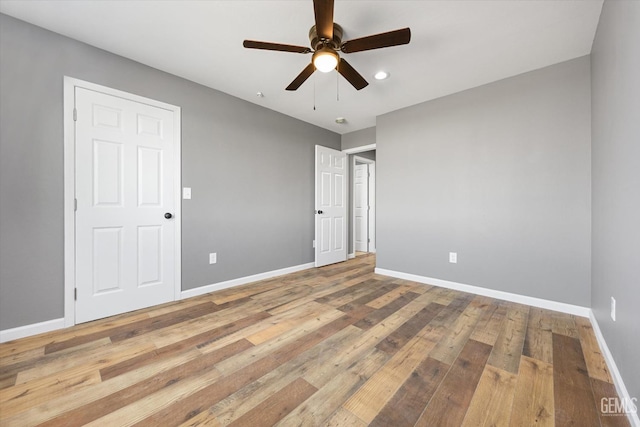 unfurnished bedroom featuring a ceiling fan, recessed lighting, baseboards, and hardwood / wood-style floors