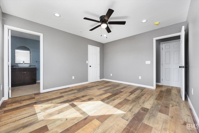 unfurnished bedroom featuring recessed lighting, hardwood / wood-style floors, a ceiling fan, ensuite bath, and baseboards