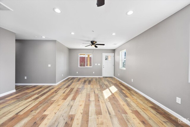 unfurnished living room with visible vents, baseboards, a ceiling fan, light wood-type flooring, and recessed lighting