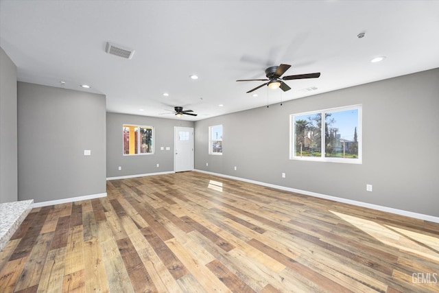 unfurnished room with recessed lighting, visible vents, baseboards, and hardwood / wood-style flooring