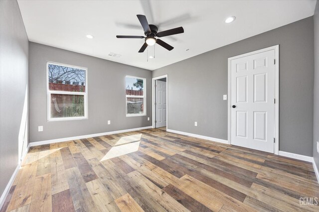 interior space with visible vents, recessed lighting, hardwood / wood-style flooring, and baseboards