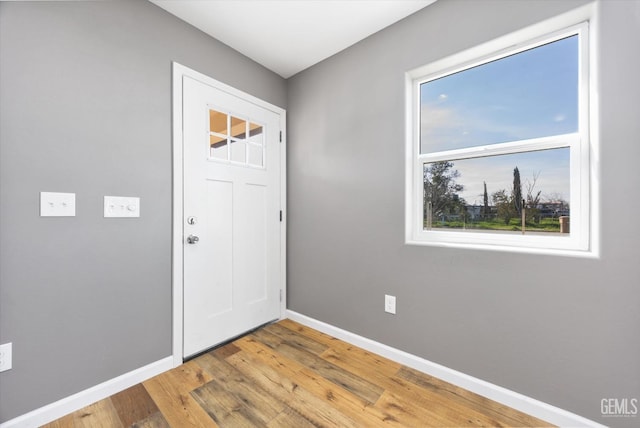 entrance foyer with light wood-type flooring and baseboards