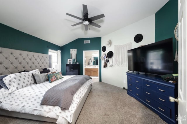 bedroom featuring ceiling fan, visible vents, carpet, lofted ceiling, and ensuite bathroom