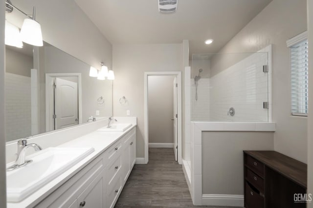 full bathroom featuring double vanity, visible vents, a sink, and tiled shower