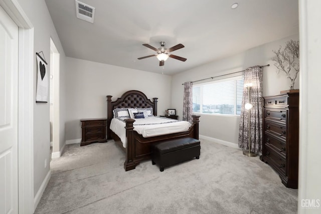 bedroom featuring light carpet, baseboards, visible vents, and a ceiling fan