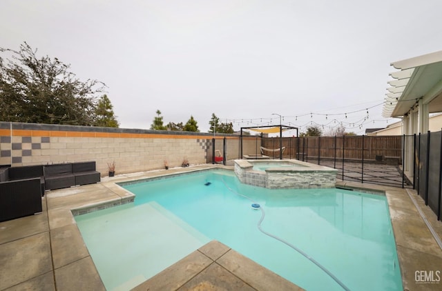 view of swimming pool with a fenced backyard, a pool with connected hot tub, and a patio