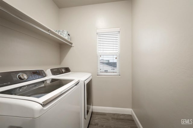 laundry area with laundry area, dark wood-style floors, baseboards, and washing machine and clothes dryer