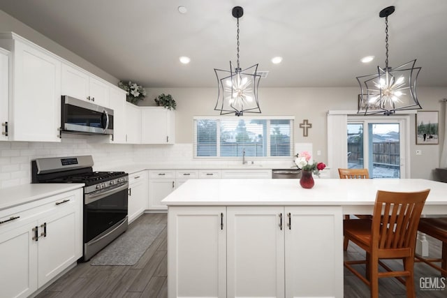 kitchen featuring appliances with stainless steel finishes, light countertops, and a kitchen island