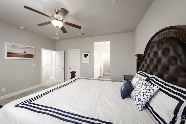 bedroom with light carpet, baseboards, visible vents, a ceiling fan, and ensuite bath