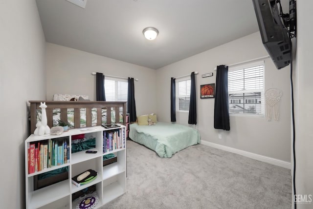 bedroom with carpet flooring and baseboards