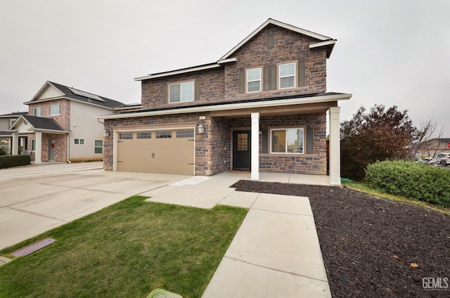 traditional-style home featuring an attached garage, covered porch, and concrete driveway