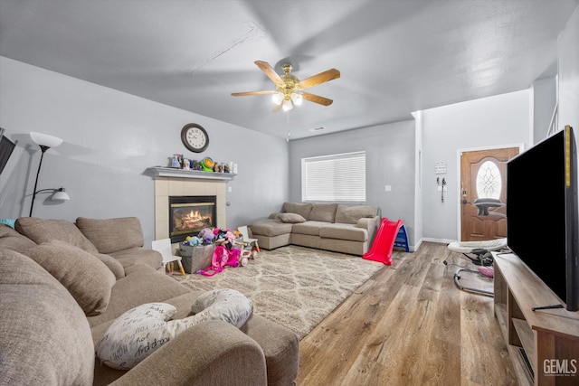 437 Rian Noelle Ct, Bakersfield, CA 93308 - living area with wood finished floors, ceiling fan, and a tile fireplace