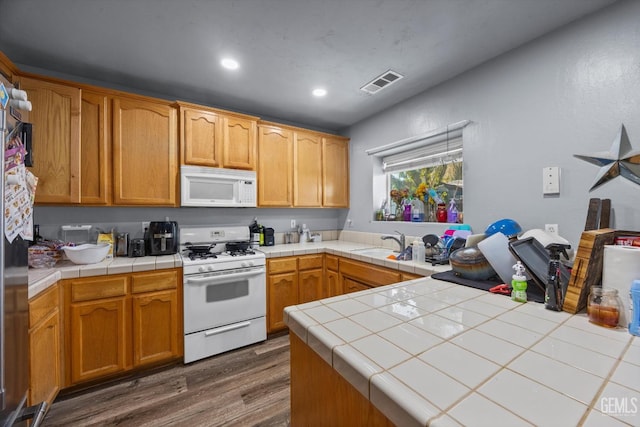 437 Rian Noelle Ct, Bakersfield, CA 93308 - kitchen featuring white appliances, dark wood finished floors, tile counters, and recessed lighting
