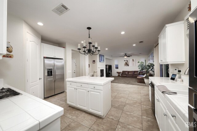 11102 Patagonia Way, Bakersfield, CA 93306 - kitchen with stainless steel appliances, tile countertops, a chandelier, recessed lighting, and a kitchen island
