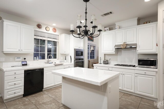 11102 Patagonia Way, Bakersfield, CA 93306 - kitchen featuring stainless steel appliances, tile counters, white cabinetry, and recessed lighting