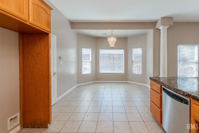 kitchen featuring dark countertops, visible vents, light tile patterned flooring, ornate columns, and stainless steel dishwasher