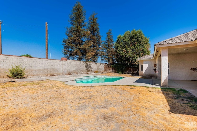 view of pool with a fenced backyard and a patio area