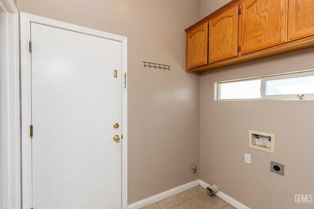 washroom with baseboards, washer hookup, light tile patterned flooring, cabinet space, and hookup for an electric dryer