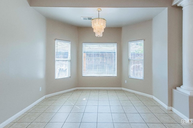 unfurnished room featuring light tile patterned floors, baseboards, visible vents, decorative columns, and a chandelier