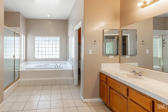 bathroom with vanity, a stall shower, tile patterned flooring, a garden tub, and toilet