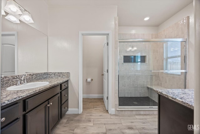 9008 Pine Breeze Ln, Shafter, CA 93263 - kitchen featuring light stone counters, stainless steel appliances, recessed lighting, decorative backsplash, and light wood-type flooring