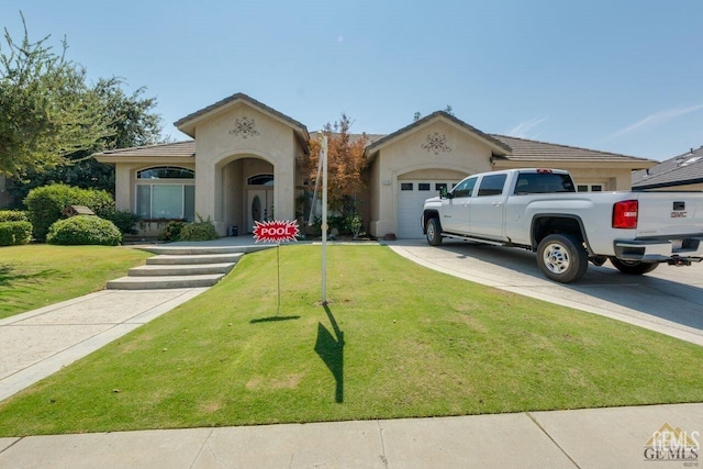 view of front of property with a garage and a front yard