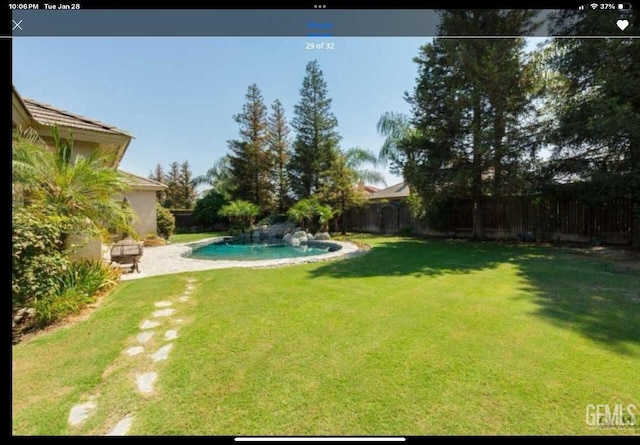 view of yard with a fenced in pool