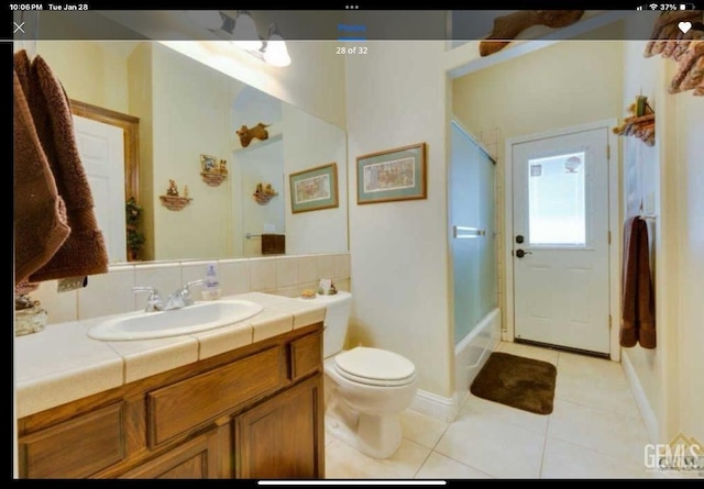 full bathroom with tile patterned flooring, vanity, bathing tub / shower combination, and toilet