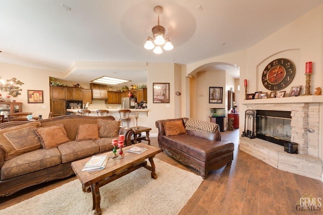 living room with hardwood / wood-style flooring and a fireplace