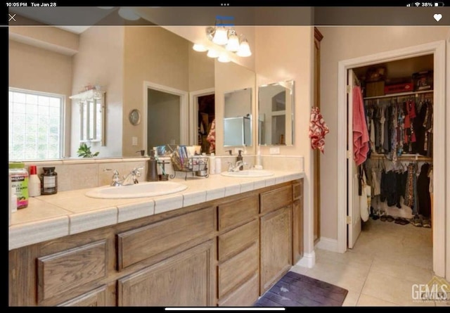 bathroom featuring tile patterned flooring and vanity