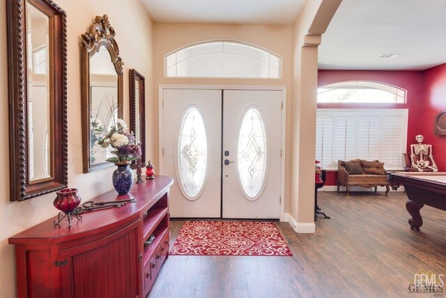 foyer featuring pool table, dark hardwood / wood-style flooring, and french doors