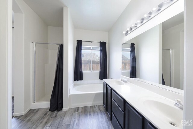 clothes washing area with hookup for a gas dryer, hookup for a washing machine, dark wood-type flooring, and cabinets