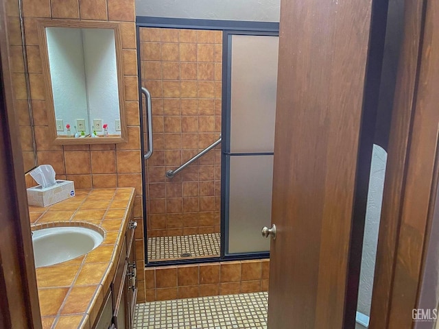 bathroom with a stall shower and vanity