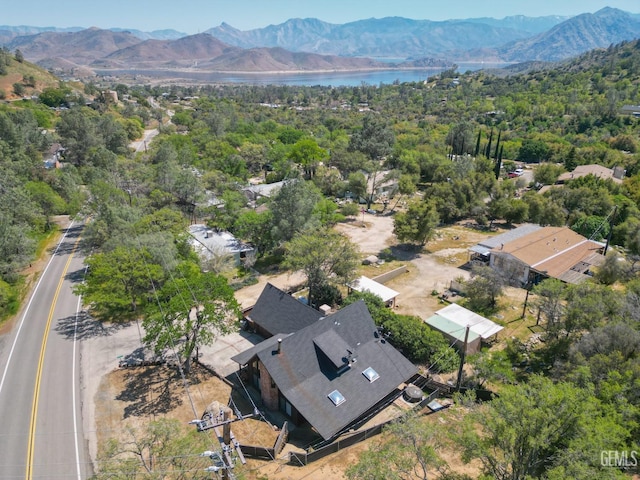 aerial view with a wooded view and a water and mountain view