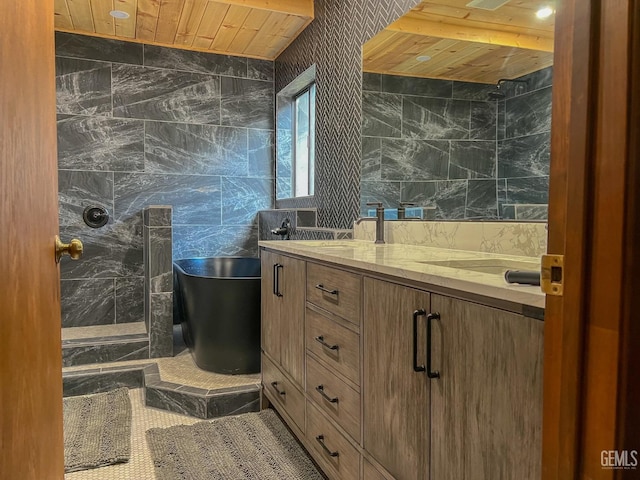 bathroom featuring a freestanding tub, double vanity, wooden ceiling, and tile walls